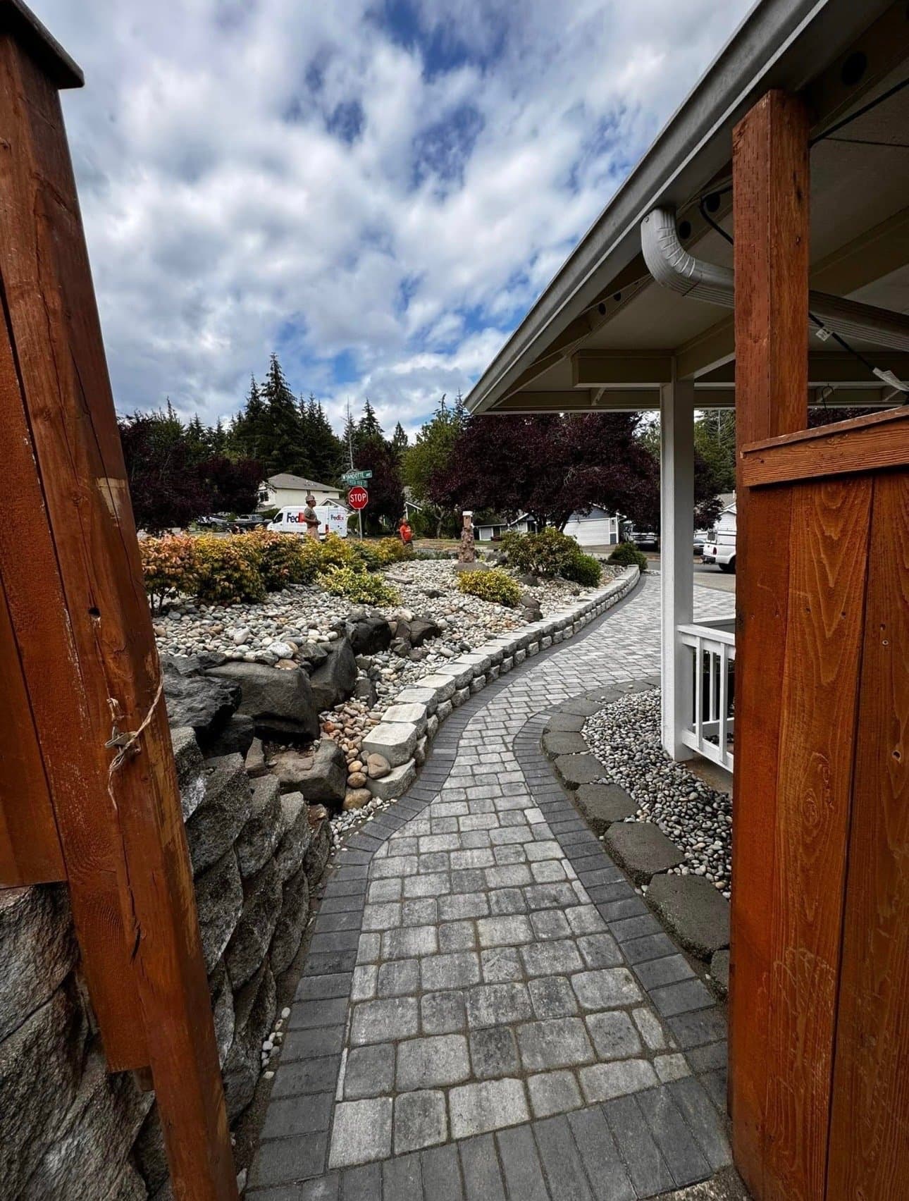 Paver walkway through a boulder and river rock garden bed